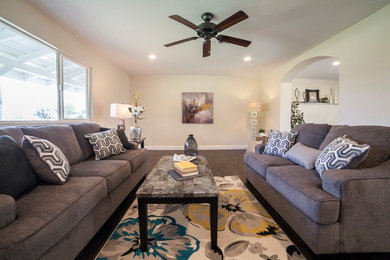Example of a mid-sized transitional open concept dark wood floor and brown floor family room design in Sacramento with beige walls and no fireplace
