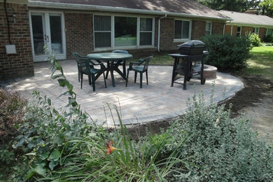 Mid-sized backyard patio in Detroit with concrete pavers and no cover.