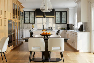 Inspiration for a large contemporary u-shaped open plan kitchen in New York with a submerged sink, recessed-panel cabinets, white cabinets, engineered stone countertops, multi-coloured splashback, engineered quartz splashback, stainless steel appliances, medium hardwood flooring, an island, beige floors and multicoloured worktops.