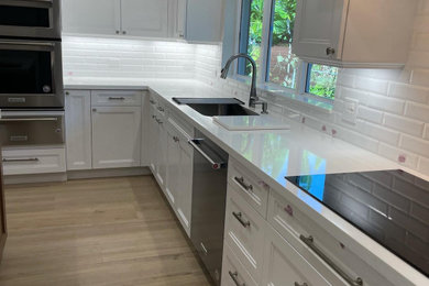 Inspiration for a traditional kitchen in Miami with all styles of cabinet, all types of cabinet finish, quartz worktops, white splashback and ceramic splashback.