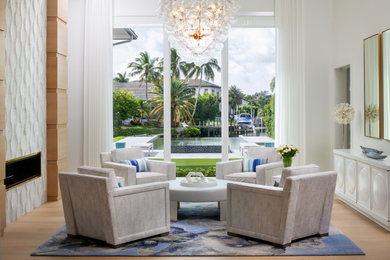 Inspiration for a contemporary light wood floor and beige floor living room remodel in Miami with white walls, a ribbon fireplace and a tile fireplace