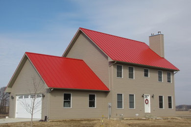 This is an example of a contemporary two-storey brown exterior in Other with vinyl siding and a gable roof.