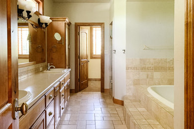 Bathroom - large traditional master ceramic tile and double-sink bathroom idea in New York with a two-piece toilet, a drop-in sink, granite countertops, a hinged shower door and a freestanding vanity