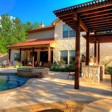 Natural Pool with rock waterfall, bridge, spa, and pergola