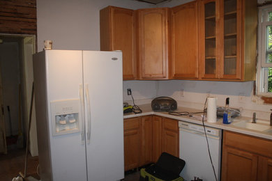 Kitchen - kitchen idea in Baltimore with medium tone wood cabinets and solid surface countertops