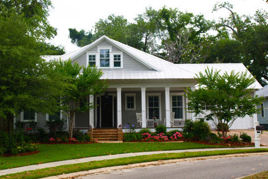 Photo of a mid-sized traditional one-storey grey exterior in New Orleans with vinyl siding and a hip roof.