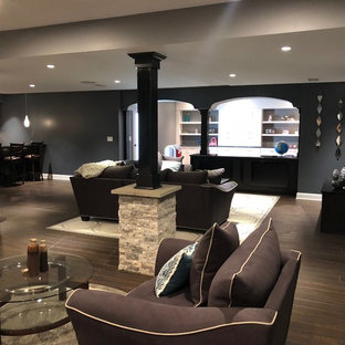 Large modern fully buried basement in Philadelphia with grey walls, terracotta flooring and brown floors.