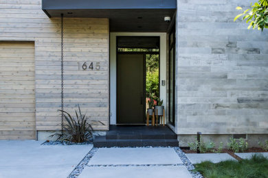 Inspiration for a large contemporary concrete paver front porch remodel in San Francisco with a roof extension
