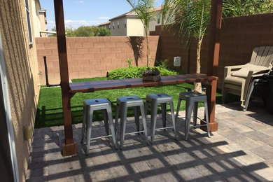 Patio - mid-sized coastal backyard concrete paver patio idea in Seattle with a pergola