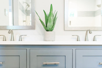 Example of a trendy master white tile and stone tile marble floor doorless shower design in Other with an undermount sink, shaker cabinets, gray cabinets, quartz countertops and a one-piece toilet
