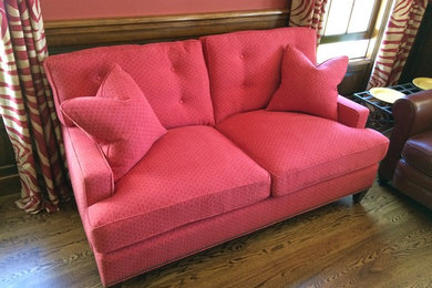 Mid-sized elegant formal and enclosed medium tone wood floor and brown floor living room photo in New York with pink walls, no fireplace and no tv