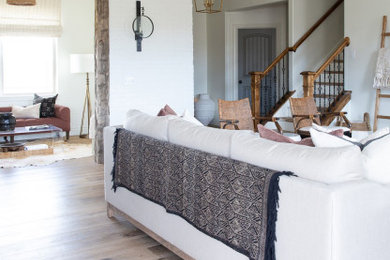 Inspiration for a large cottage open concept light wood floor and beige floor living room remodel with white walls