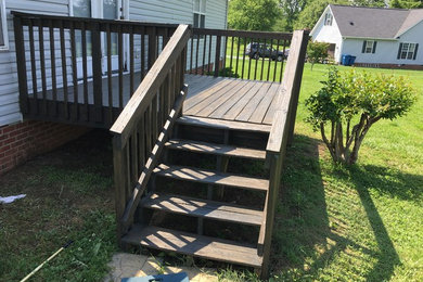 Example of a small backyard deck design in Other with no cover