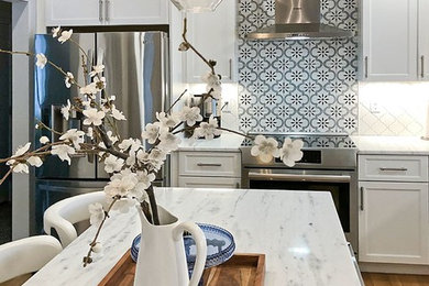 Inspiration for a transitional light wood floor eat-in kitchen remodel in Boston with an island