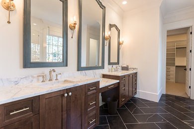 Inspiration for a mid-sized transitional 3/4 bathroom in Atlanta with recessed-panel cabinets, dark wood cabinets, a freestanding tub, a corner shower, white tile, ceramic tile, white walls, porcelain floors, an undermount sink, marble benchtops, black floor and a hinged shower door.