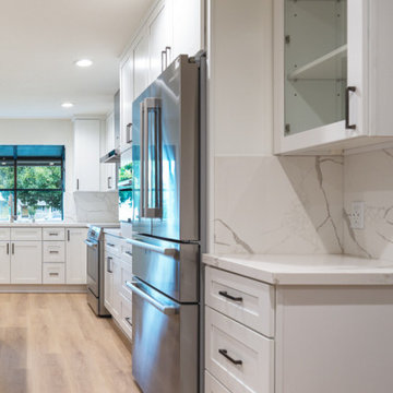 Modern White Shaker Kitchen with Navy Blue Island and Waterfall Quartz Counterto