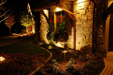 This is an example of a small traditional partial sun front yard brick landscaping in Minneapolis for summer.