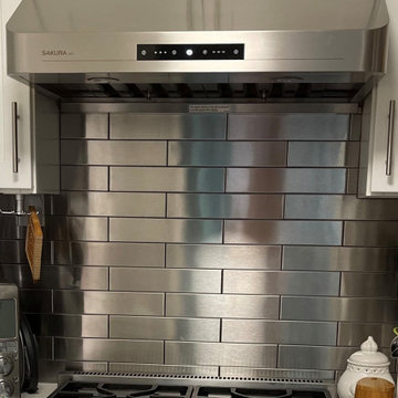 San Francisco area White Kitchen with Stainless Steel Backsplash