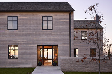 Photo of a modern two-storey grey house exterior in Chicago with wood siding and a shed roof.