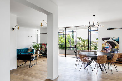 Example of a large trendy open concept light wood floor living room design in Los Angeles with white walls