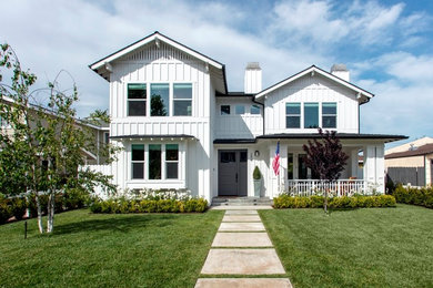 Inspiration for a two-storey white house exterior in Orange County with concrete fiberboard siding and a shingle roof.