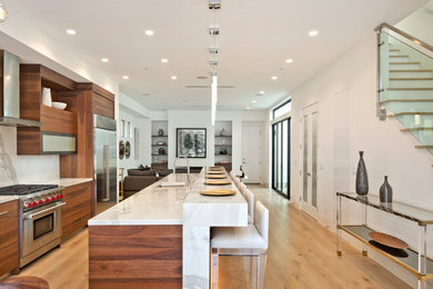 Inspiration for a mid-sized 1950s galley light wood floor and beige floor open concept kitchen remodel in Orange County with an undermount sink, flat-panel cabinets, dark wood cabinets, marble countertops, white backsplash, marble backsplash, stainless steel appliances and an island