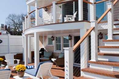 Inspiration for a large coastal beige three-story wood gable roof remodel in Boston