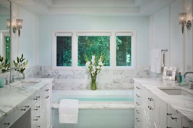Large minimalist master white tile and marble tile marble floor and white floor bathroom photo in Atlanta with flat-panel cabinets, white cabinets, white walls, an undermount sink, marble countertops and a hinged shower door
