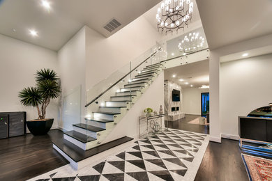 Mid-sized trendy painted straight glass railing staircase photo in Houston with painted risers