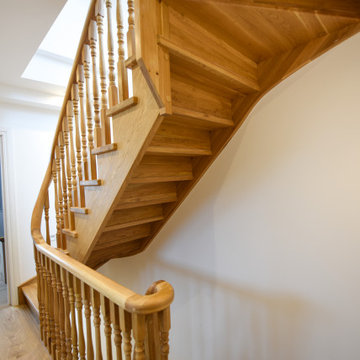 Traditional oak staircase with continous handrail