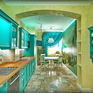 This is an example of a mid-sized mediterranean single-wall separate kitchen in Moscow with an undermount sink, raised-panel cabinets, turquoise cabinets, wood benchtops, multi-coloured splashback, ceramic splashback, black appliances, porcelain floors, no island, multi-coloured floor and orange benchtop.