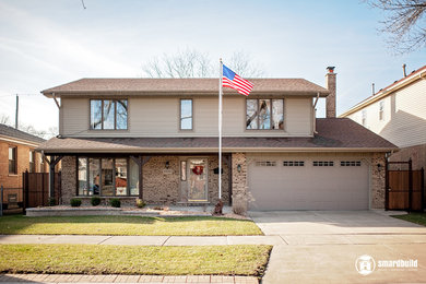 Inspiration for a mid-sized timeless gray two-story concrete fiberboard exterior home remodel in Chicago with a shingle roof