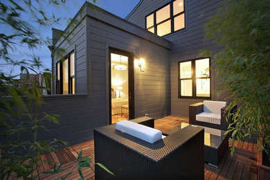 Inspiration for a large modern backyard patio in San Francisco with an outdoor kitchen, decking and no cover.