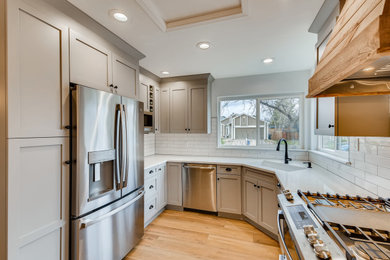 Inspiration for a craftsman kitchen remodel in Louisville with a single-bowl sink, raised-panel cabinets, gray cabinets, quartzite countertops, white backsplash, subway tile backsplash, a peninsula and white countertops
