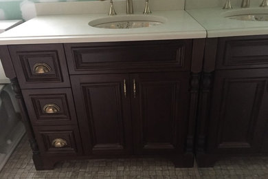 Inspiration for a mid-sized timeless 3/4 mosaic tile floor and beige floor bathroom remodel in New York with recessed-panel cabinets, dark wood cabinets, blue walls and solid surface countertops