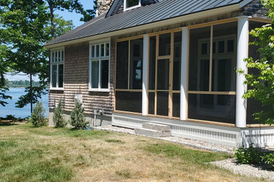 Beach style screened-in porch photo in Portland Maine