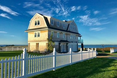 Example of a wood house exterior design in Providence with a gambrel roof and a shingle roof