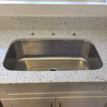 White shaker kitchen cabinets with Sparking white quartz countertops