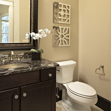 Bathroom with dark wood cabinets and cream walls