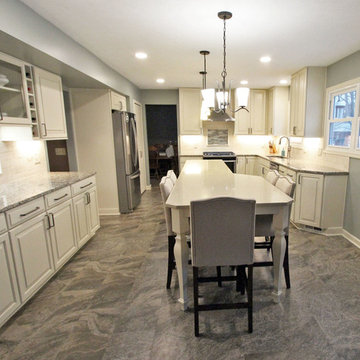 Beige Kitchen with Extra Large Island, Tile Backsplash and Granite Countertops