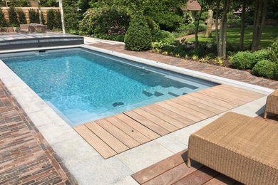 Großer Moderner Pool neben dem Haus in rechteckiger Form mit Natursteinplatten in Hamburg