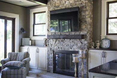 Inspiration for a transitional sunroom remodel in Milwaukee with a standard fireplace and a stone fireplace