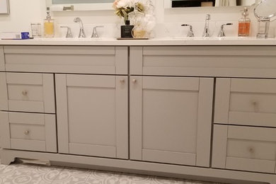 Bathroom - mid-sized transitional 3/4 ceramic tile and multicolored floor bathroom idea in Toronto with shaker cabinets, brown cabinets, white walls, an undermount sink, quartz countertops and white countertops