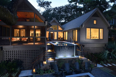 Inspiration for a large industrial gray one-story mixed siding house exterior remodel in Charleston with a shingle roof