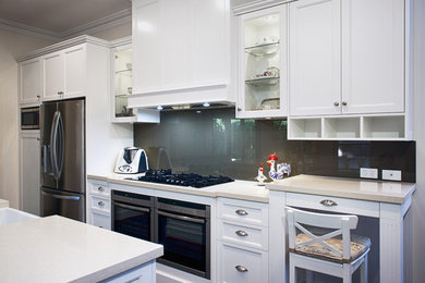 Inspiration for a traditional kitchen in Perth with white cabinets, quartz benchtops, grey splashback, glass sheet splashback, stainless steel appliances, with island, shaker cabinets and beige benchtop.
