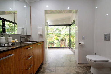 This is an example of a large modern master bathroom in Brisbane with a freestanding tub, an open shower, white tile, porcelain tile, marble floors, an undermount sink, engineered quartz benchtops and an open shower.
