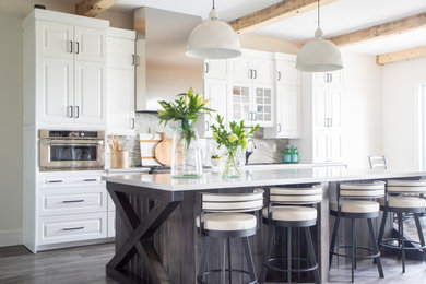 Transitional l-shaped vinyl floor and gray floor eat-in kitchen photo in Toronto with a drop-in sink, raised-panel cabinets, quartz countertops, stone slab backsplash, stainless steel appliances, an island and white countertops