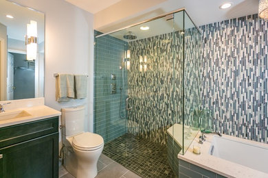 Example of a large transitional master multicolored tile and matchstick tile porcelain tile and gray floor walk-in shower design in Las Vegas with recessed-panel cabinets, gray cabinets, an undermount tub, a two-piece toilet, gray walls, an undermount sink, quartz countertops, a hinged shower door and white countertops