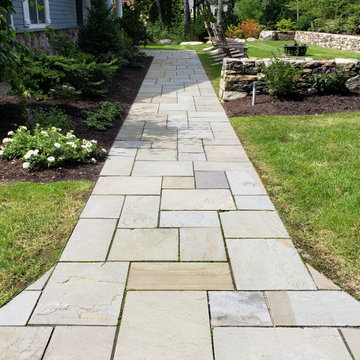 An extensive landscape project with stonewalls, patio, dry river bed & more