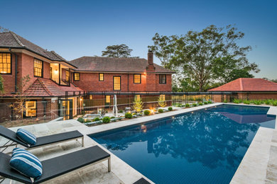 Photo of a contemporary rectangular pool in Sydney with tile.